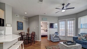 A modern living room with a dining area, a kitchen, and a bedroom. - 1st FLOOR LARGE 1BR, BEAUTIFUL Beach Getaway!  Pool, Hot Tub, Sauna & More (Corpus Christi)