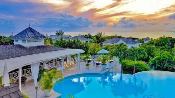 A resort with a swimming pool, covered outdoor seating, and a view of the ocean at sunset. - Sugar Hill - B8 by Island Villas (Holetown)