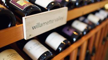 A wine rack with labels indicating different wine varieties.