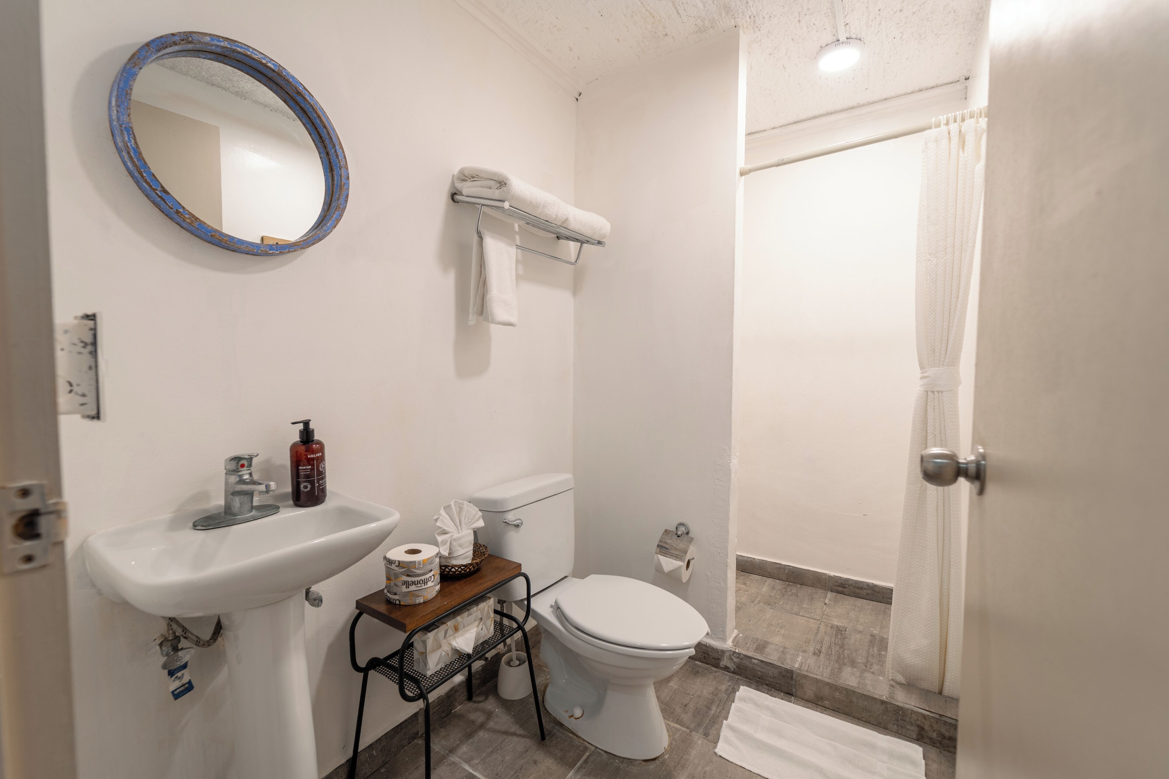 A bathroom with a sink, toilet, and shower.