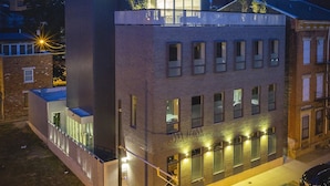 A modern building with a flat roof, large windows, and a balcony. - Unique, contemporary 1,500ft2 2BR/2.5BA apt - OTR (Cincinnati)