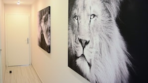 A hallway with two large lion portraits on the wall, a white door, and a light fixture on the ceiling. - SUPERB VILLA (220m2), SEA AND VIEW BETWEEN ST MAXIME AND ISSAMBRES (Sainte-Maxime)