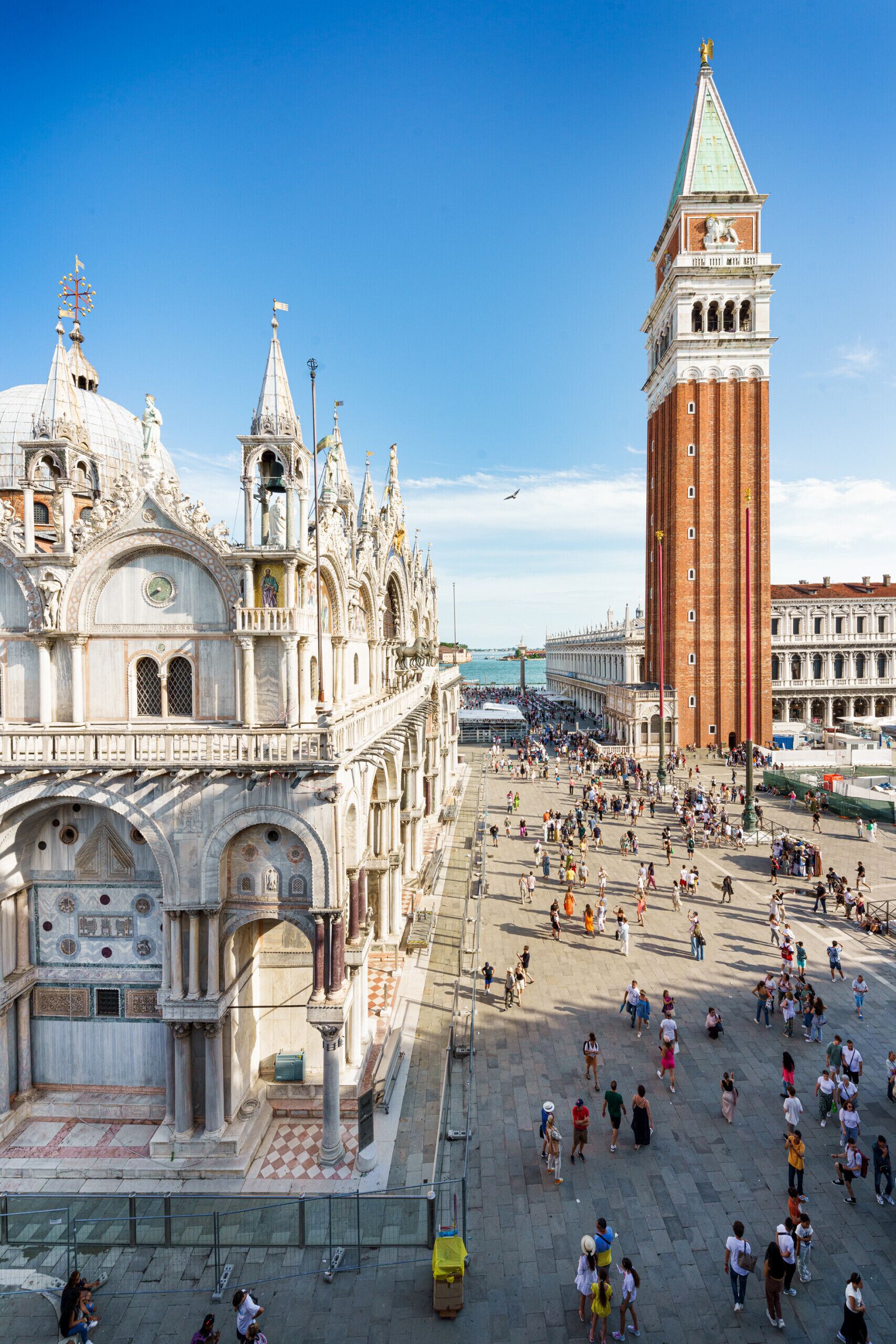 A historic square with a prominent bell tower and ornate buildings.