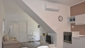 A modern apartment with a loft-style living area, kitchenette, and a dining space. - Seaside house with private garden (Follonica)