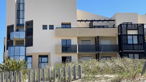 A modern multi-story building with balconies, large windows, and a flat roof. - Magnificent 60m² apartment - 6 people with ocean view terrace South Beach  (Lacanau)