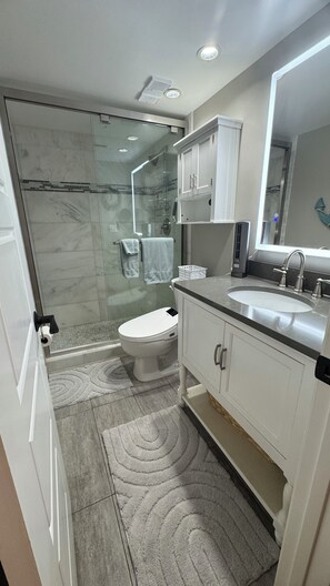 Combined shower/tub, hair dryer, towels, toilet paper - Ground Floor Luxury Condo Fully Updated With Great Ocean View - Unit 49 (Cocoa Beach)