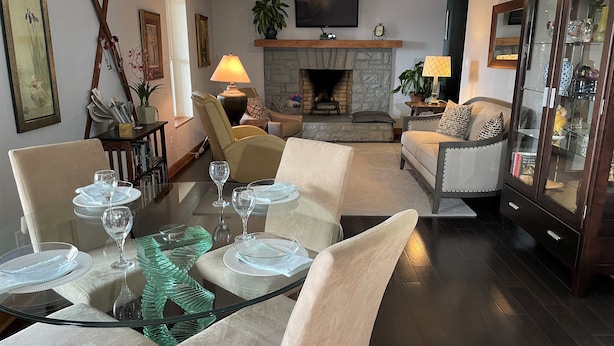 A dining area with a glass table set for six, surrounded by beige upholstered chairs. - King en suites.  Enjoy panoramic views of city and mountains, Walkable to town. (Asheville)