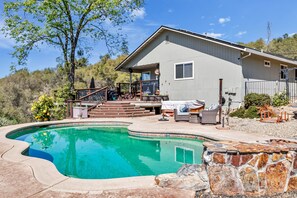 A house with a swimming pool, outdoor furniture, and a stone wall. - Country Living in Cozy Luxury...Welcome long term renters and  furry friends (Placerville)