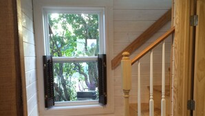 A wooden staircase with a window leading to an outdoor area. - Beautifully Renovated Ocean Front Cottage With Spectacular Views.. (Jonesport)