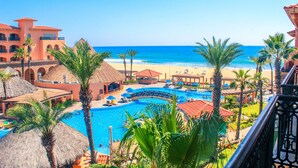 A resort with a swimming pool, beach, and palm trees. - Club Solaris Los Cabos (San José del Cabo)