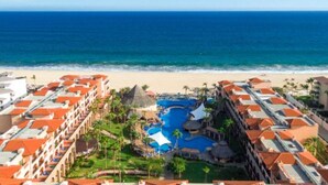 A resort with multiple buildings, a central pool area, and a beach view. - Club Solaris Los Cabos (San José del Cabo)