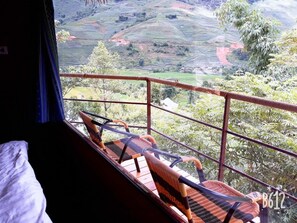 A balcony with wicker chairs and a view of terraced fields. - Eco Hills Homestay (Ta Van)