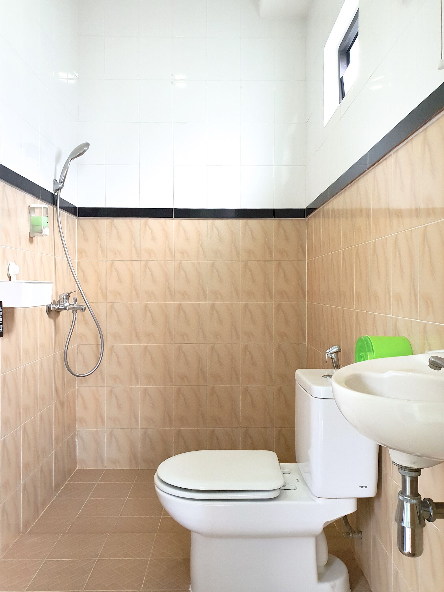 A bathroom with a toilet, sink, and shower.