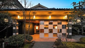 A traditional Japanese building with a tiled roof, a tiled entrance, and a well-lit facade. - Awazu-Spa Tourist Hotel Kitahachi (Komatsu)