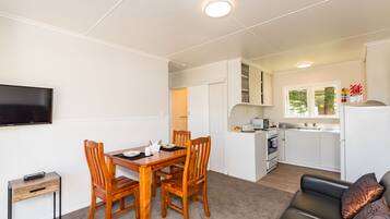 Waitangi Beach Bach 30B | Living area | Flat-screen TV