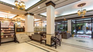 A spacious lobby with marble flooring, a reception desk, comfortable seating areas, and large windows offering a view of the outside. - Hotel Le Himalaya (Kathmandu)