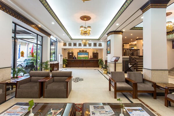A hotel lobby with a reception desk, seating area, and a staircase. - Hotel Le Himalaya by Best Resort Nepal (Kathmandu)