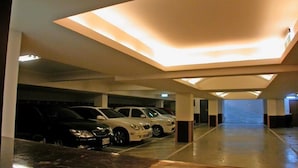 A multi-level parking garage with modern lighting and a clean, polished floor. - Reedon Boutique Hotel (Taipei)