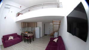 A modern apartment with a living area, kitchen, and a balcony. - Bebi Apartments (Sarandë)