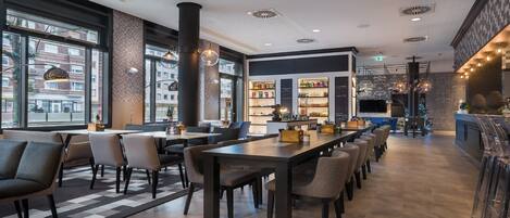 A modern restaurant with a bar area, seating arrangements, and a view of the street outside.