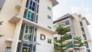 A multi-story building with a prominent 'D' on the facade, large windows, and a modern architectural design. - The Cube Residence Government Complex Laksi (Bangkok)