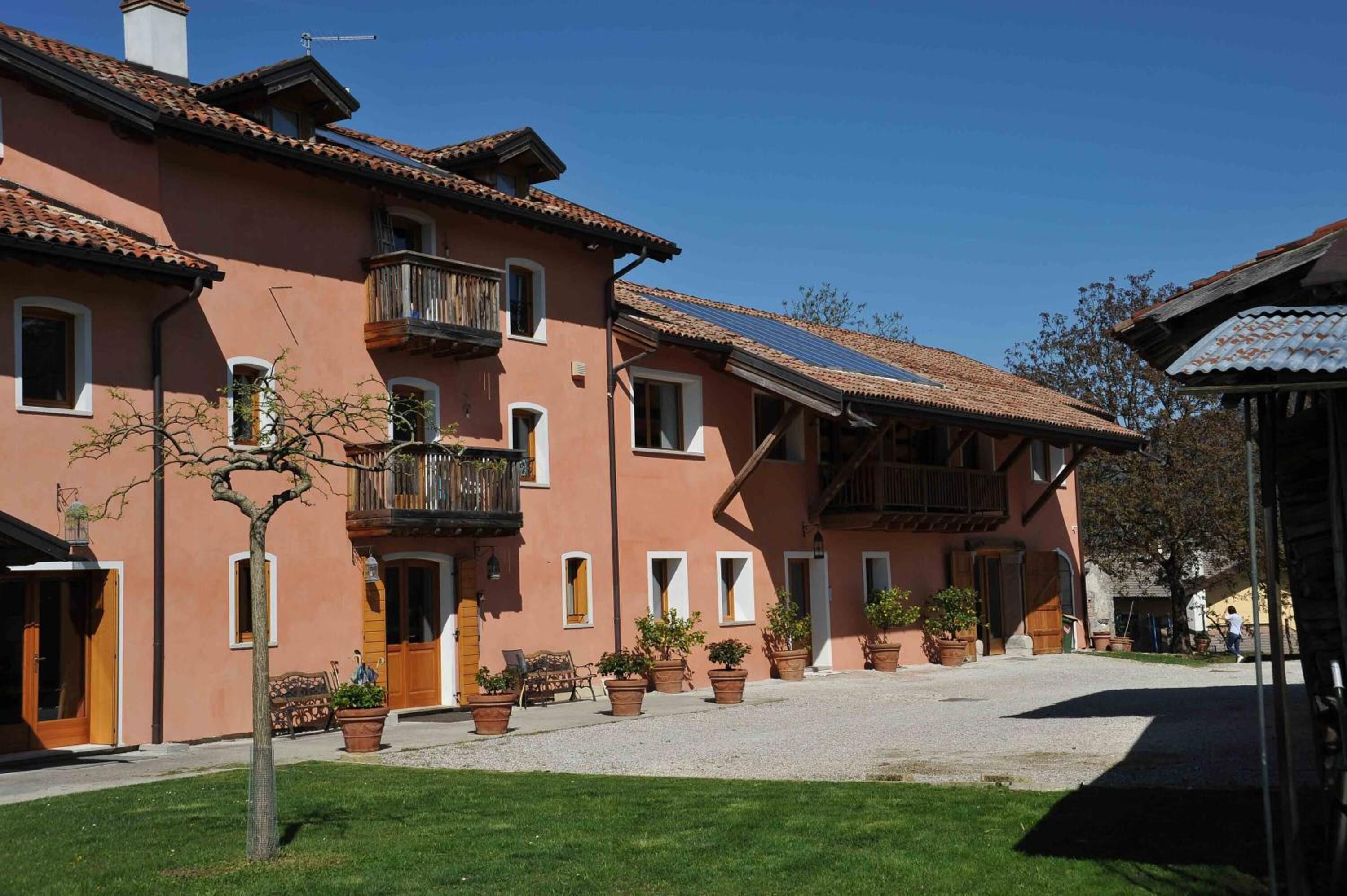 A traditional building with a courtyard, balconies, and potted plants.