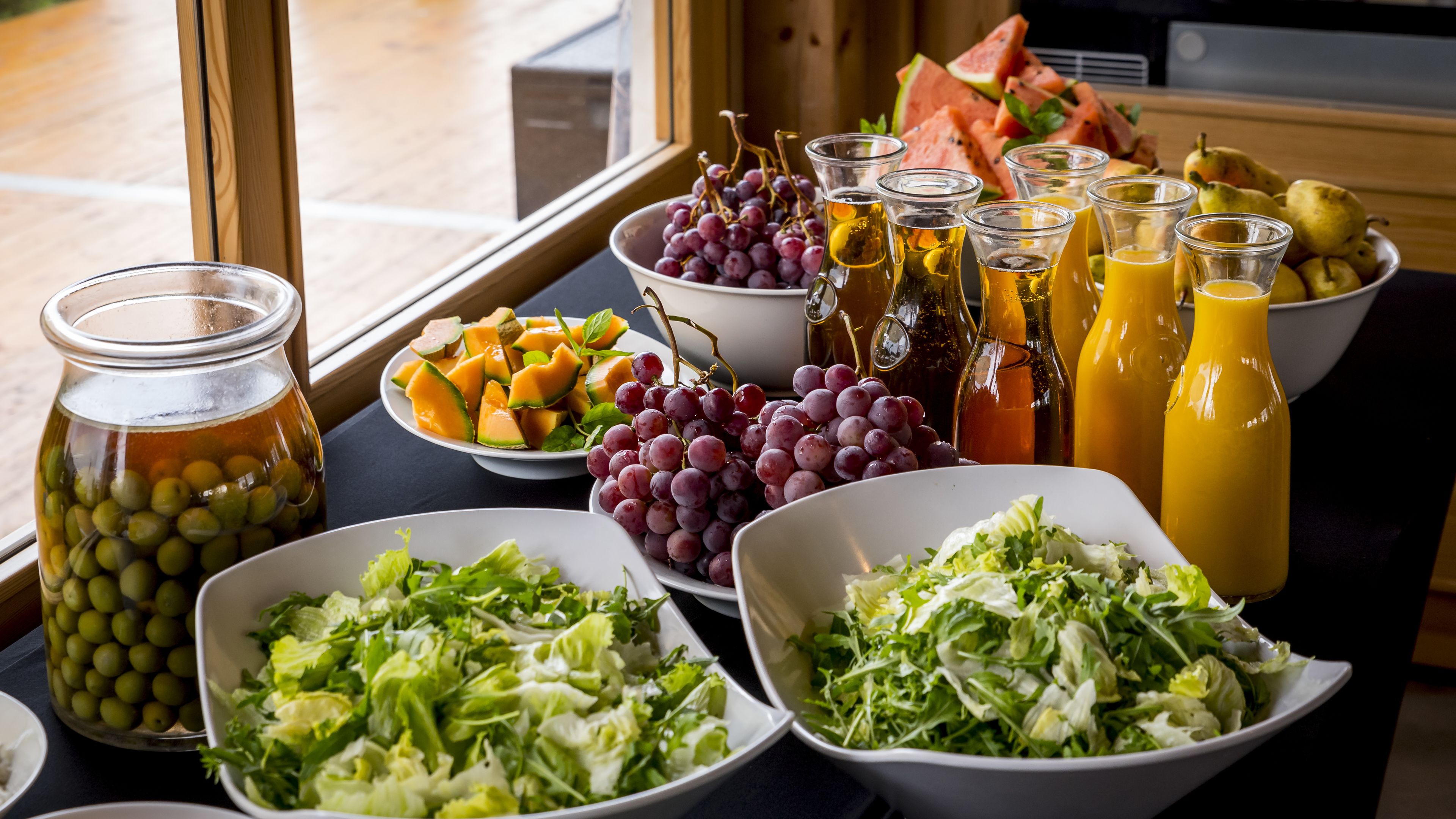 A buffet table with various food items and beverages.