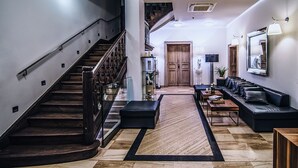 A modern living room with a staircase, a sofa set, and a coffee table. - Jakubus (Wilków)