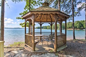 A wooden gazebo with a table and chairs, overlooking a lake. - Keowee Keys Home w/ Mountains View & Lake Access! (Salem)