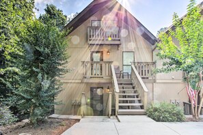 A two-story building with a wooden exterior, a front door, and a staircase leading to the second floor. - Keowee Keys Home w/ Mountains View & Lake Access! (Salem)