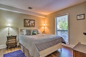 A bedroom with a bed, two bedside lamps, a dresser, a map artwork, and a window with blinds. - Keowee Keys Home w/ Mountains View & Lake Access! (Salem)