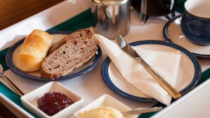 A tray with bread, butter, jam, and a coffee pot. - Cedars Apartment (Dunoon)