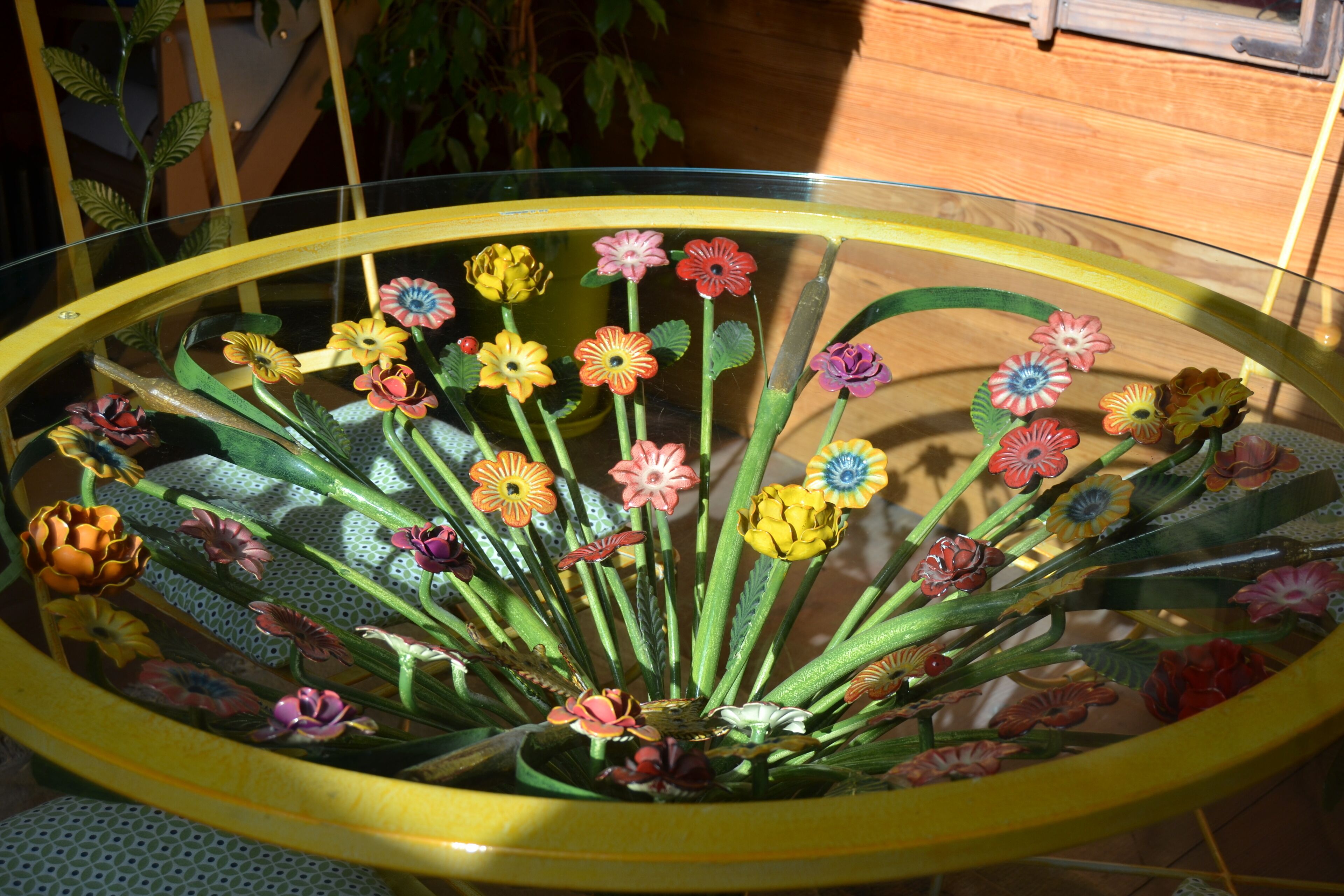 A glass table with a floral arrangement.