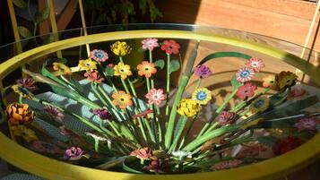 A glass table with a floral arrangement.