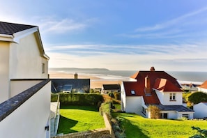 Stunning sea views surround homes with manicured lawns and hedges.