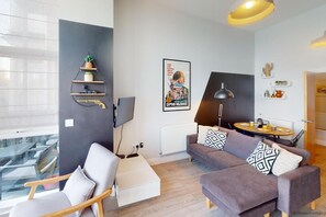 Apartamento panorâmico | Área de estar | TV, DVD player, livros, serviços de streaming