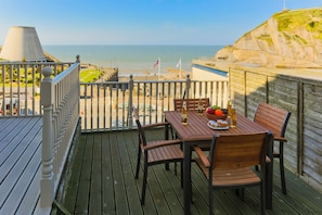 Enjoy a romantic meal for two on this deck overlooking the ocean and sandy beach.