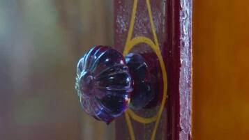A close-up of a door handle with a decorative glass knob.