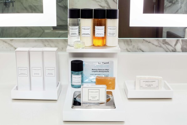 A display of various Gilchrist & Somme products including shampoo, conditioner, body lotion, and facial soap.
