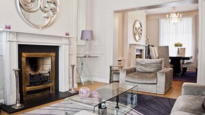 A spacious living room with a fireplace, a glass coffee table, and a comfortable seating area. - The Bono Suite- hiphipstay (Dublin)