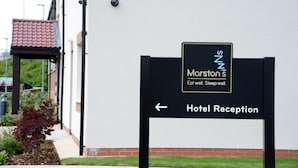 A sign for Marston's Hotel Reception with an arrow pointing left.