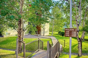 A wooden pathway leading to a building with a sign indicating Building 3 and room numbers 2301-2336. - Mtn Views-Heated Pool-Hot Tub-Near Free Bus/Trails (Steamboat Springs)