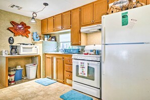 Enjoy cooking in this kitchen with a refrigerator, oven, and cabinets.
