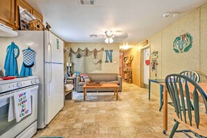 Enjoy cooking and dining in this functional kitchen with a stove, refrigerator, and dining area.