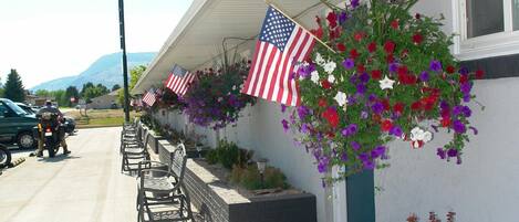 A building with American flags and flower baskets on the exterior wall.