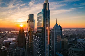 A cityscape with modern skyscrapers, including a prominent building with a unique spire, during sunset. - Four Seasons Hotel Philadelphia at Comcast Center (Philadelphia)