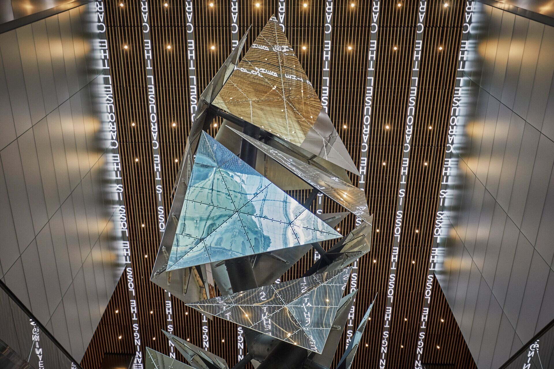 A modern interior with geometric metal structures and vertical wooden slats.