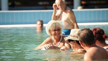 A swimming pool with people in the water.