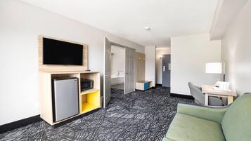 Desk, iron/ironing board, bed sheets