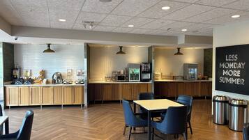 A modern cafe with a wooden counter, seating area, and a chalkboard sign.